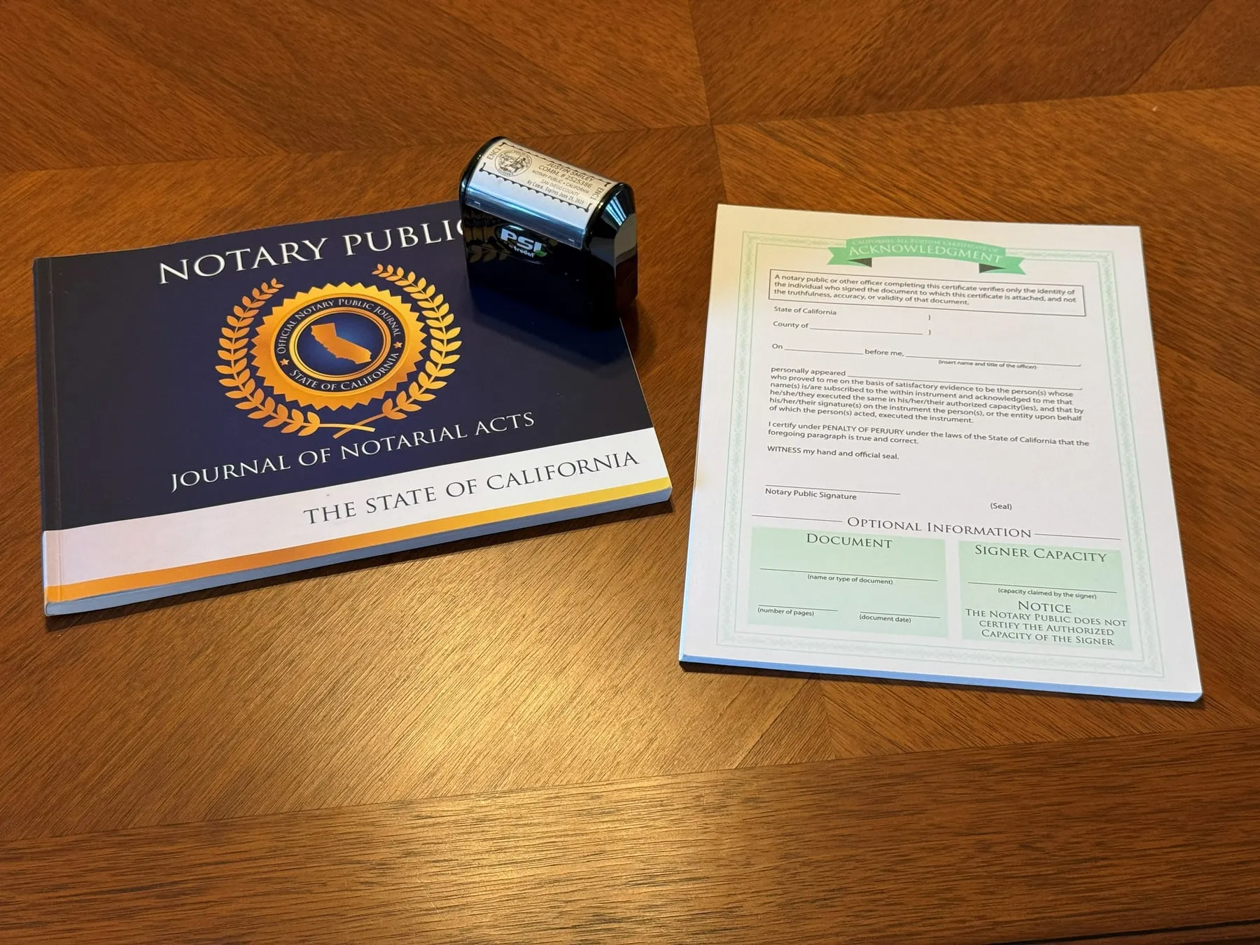 A notary journal, seal and blank California acknowledgment certificate on a table