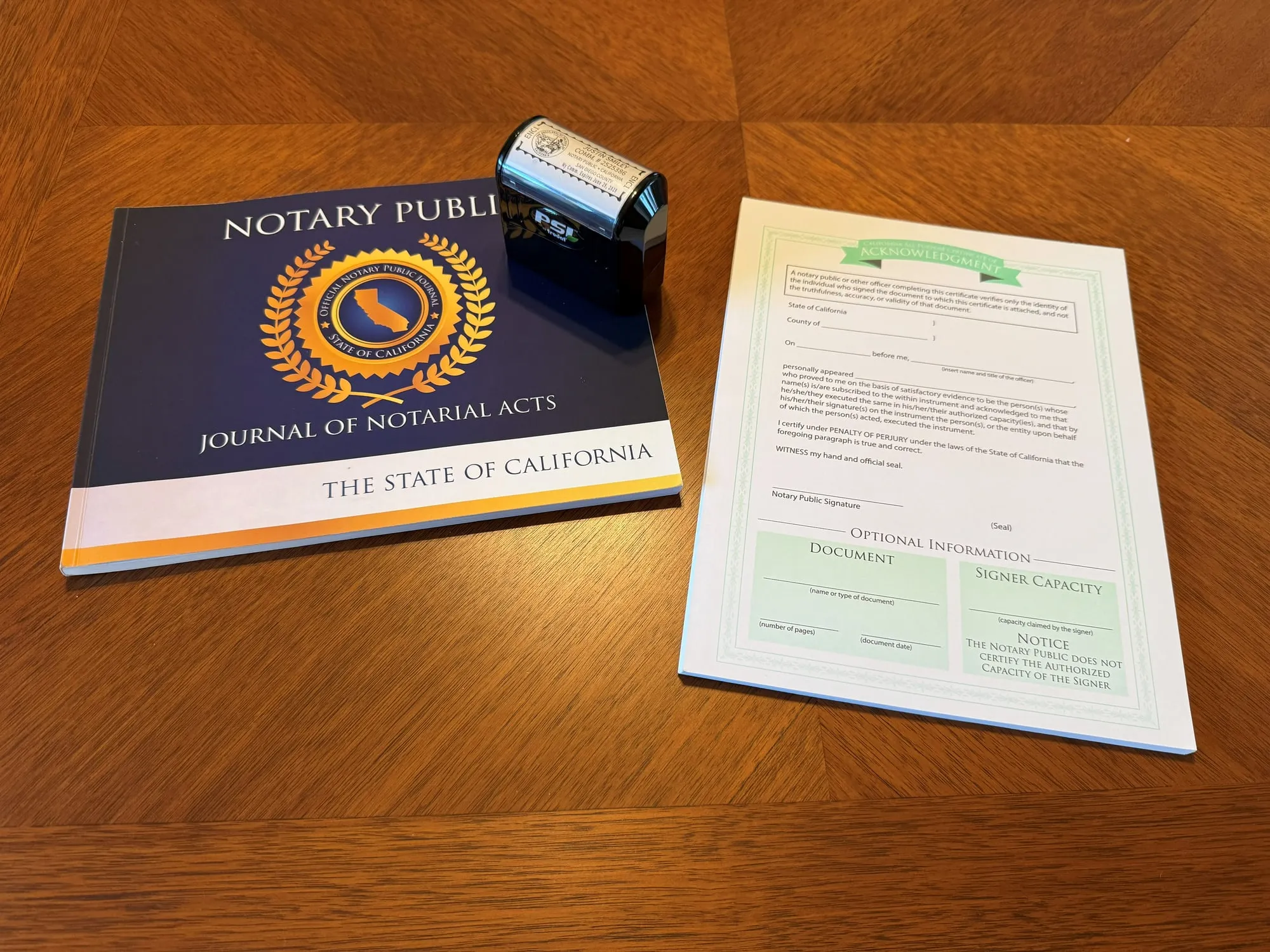 A California notary journal, seal and blank acknowledgment certificate on a wooden table