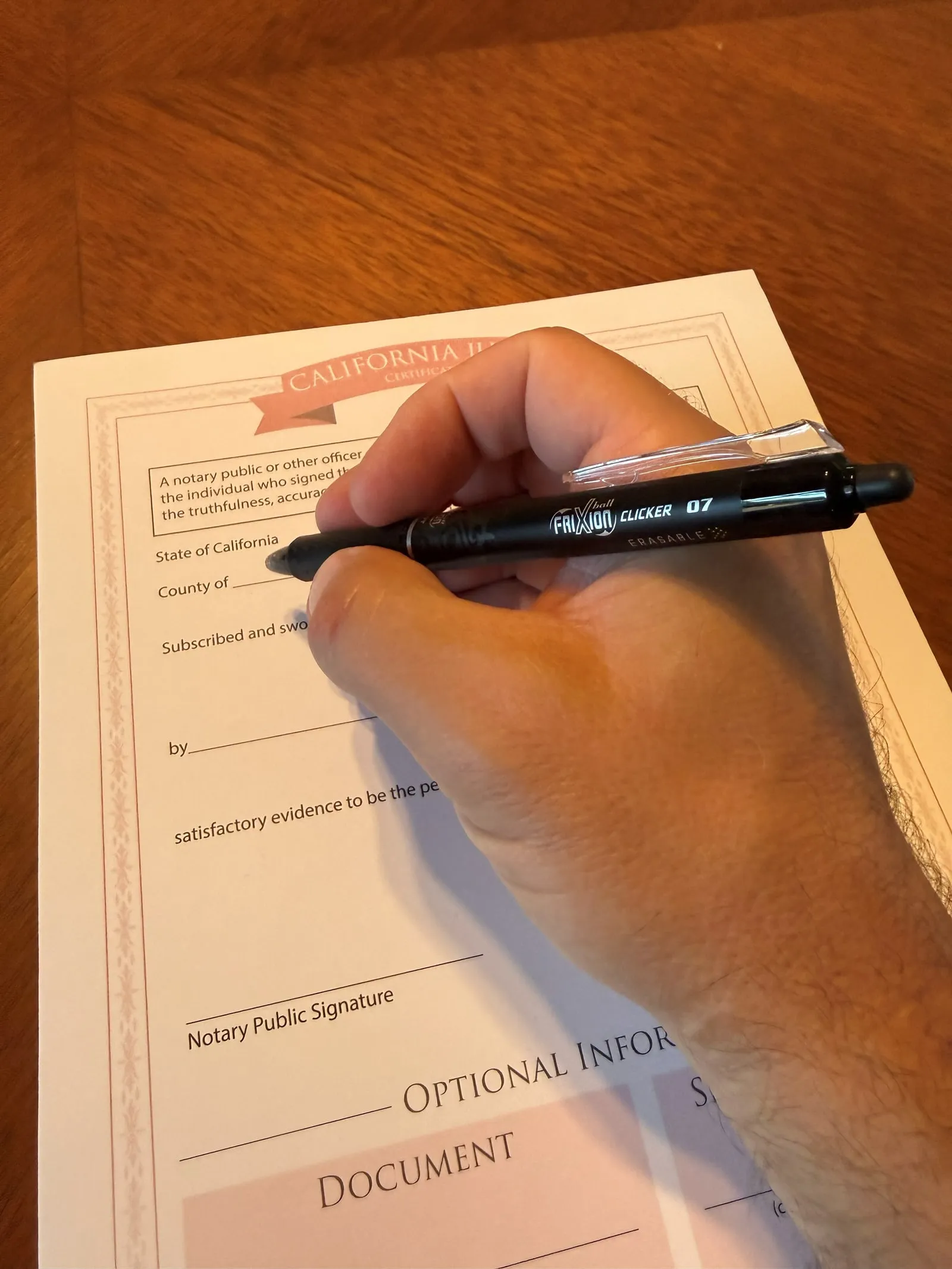 Completing a California notarial certificate at a table